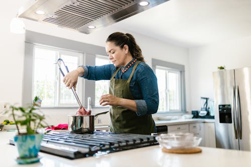 Woman Cooking Octopus in Domestic Kitchen
