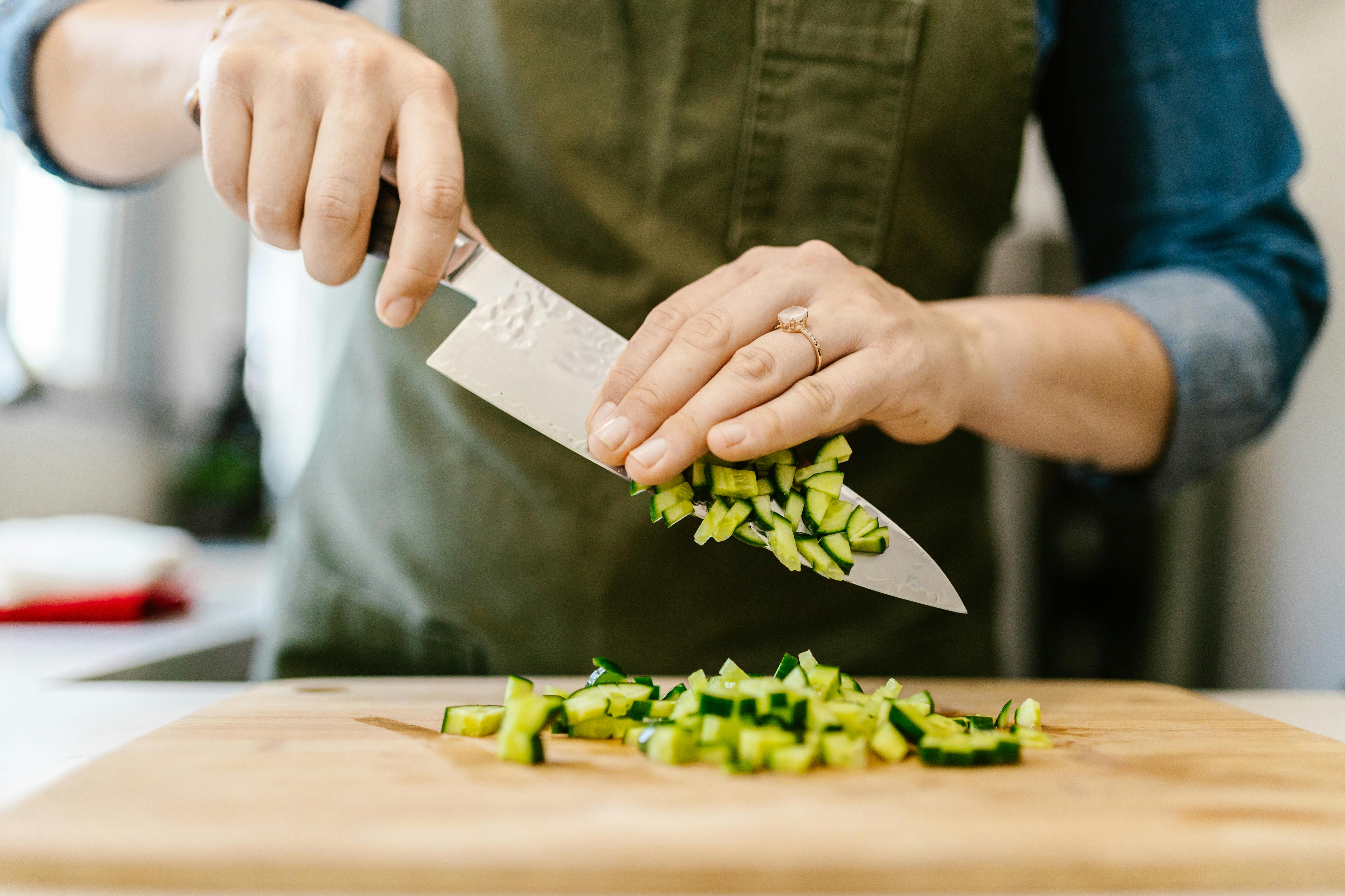 Chef chopping carrot sticks into a small dice, closeup shot. Man performing  good knife skills during cooking a meal Stock Photo - Alamy