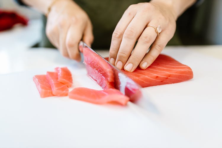 Slicing Raw Fish In Close Up