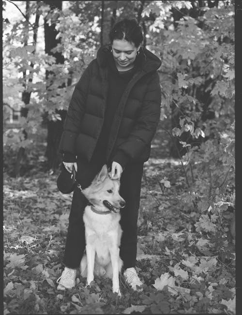 A Grayscale of a Women with Her Pet Dog