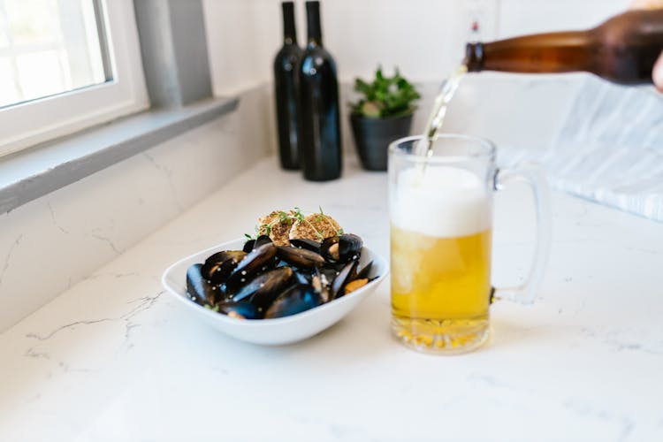 Clams And Scallops Served With Glass Of Light Bear