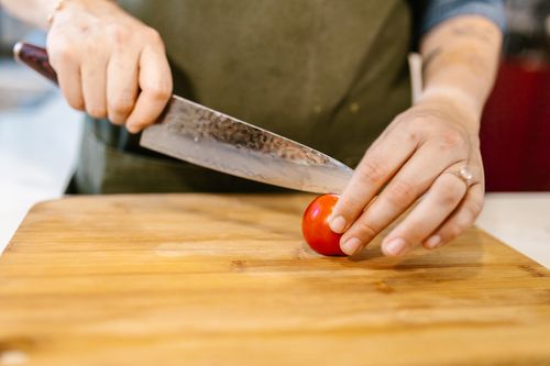 Close-up View of Chef Cutting Vegetable · Free Stock Photo