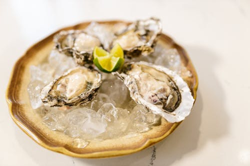 Free Fresh Oysters Served with Ice and Lime Stock Photo