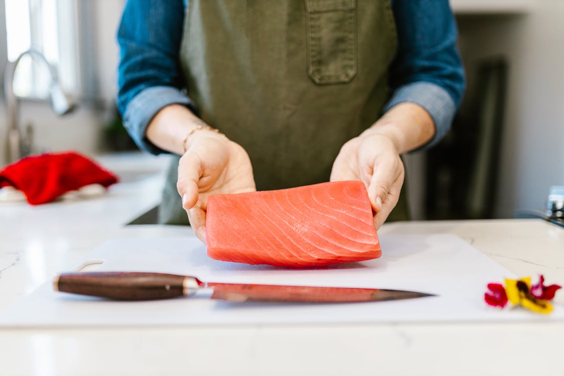 Free Woman Holding Fish Fillet Stock Photo