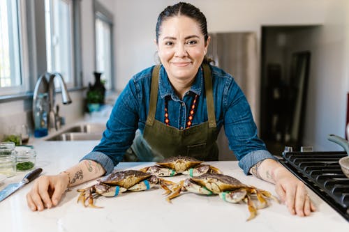 Free Smiling Chef over Crabs in Kitchen Stock Photo