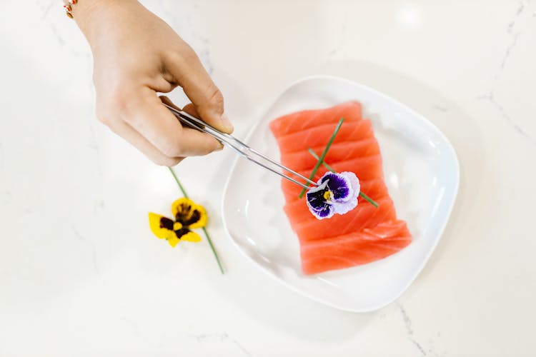 Garnishing Sashimi On A Plate