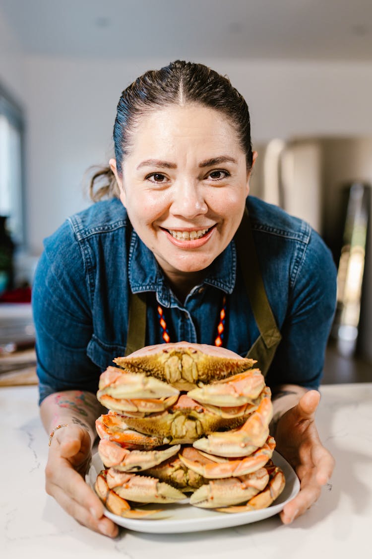 Smiling Chef Holding Plate With Seafood