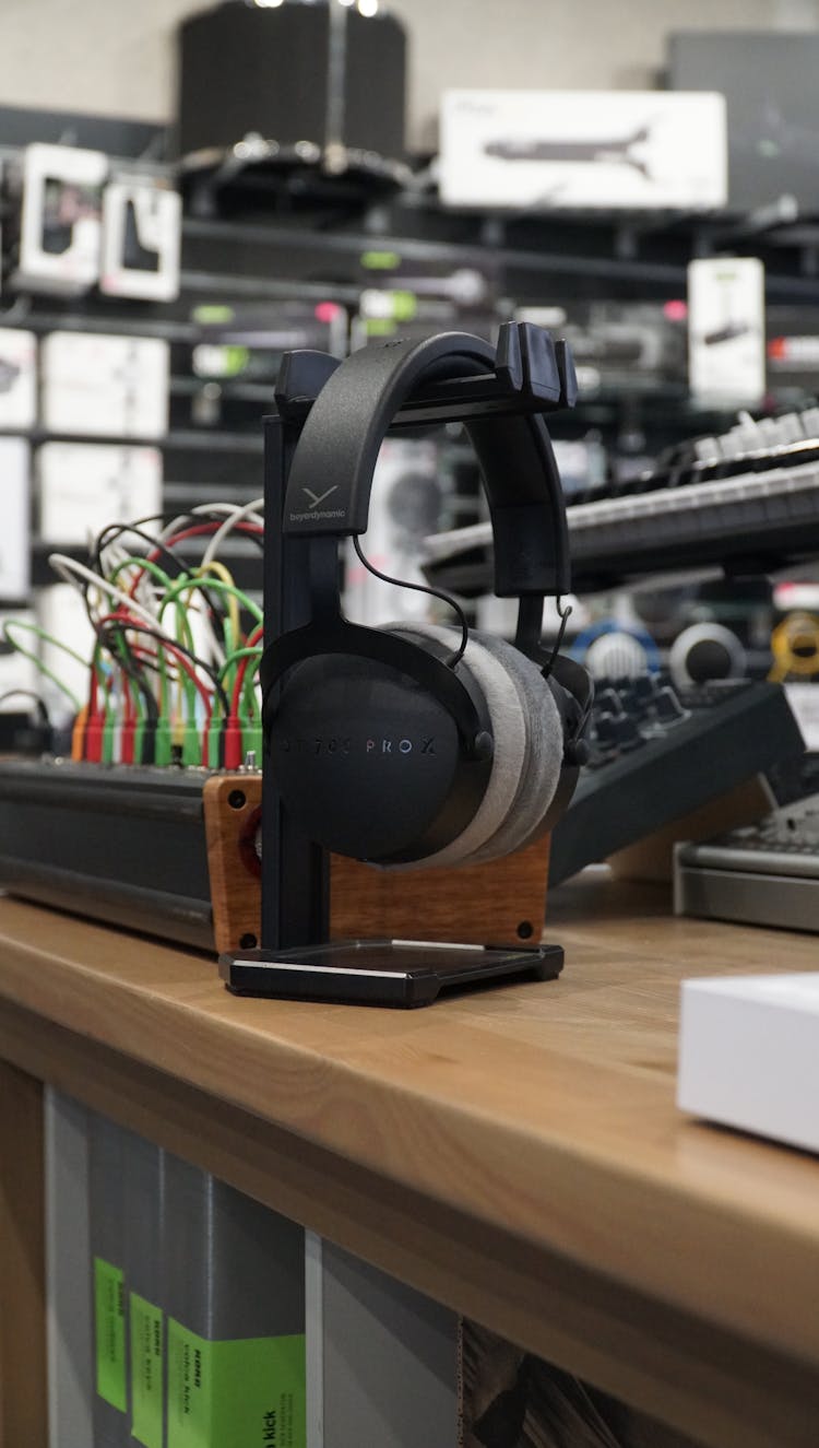 A Pair Of Headphones On A Headphone Stand