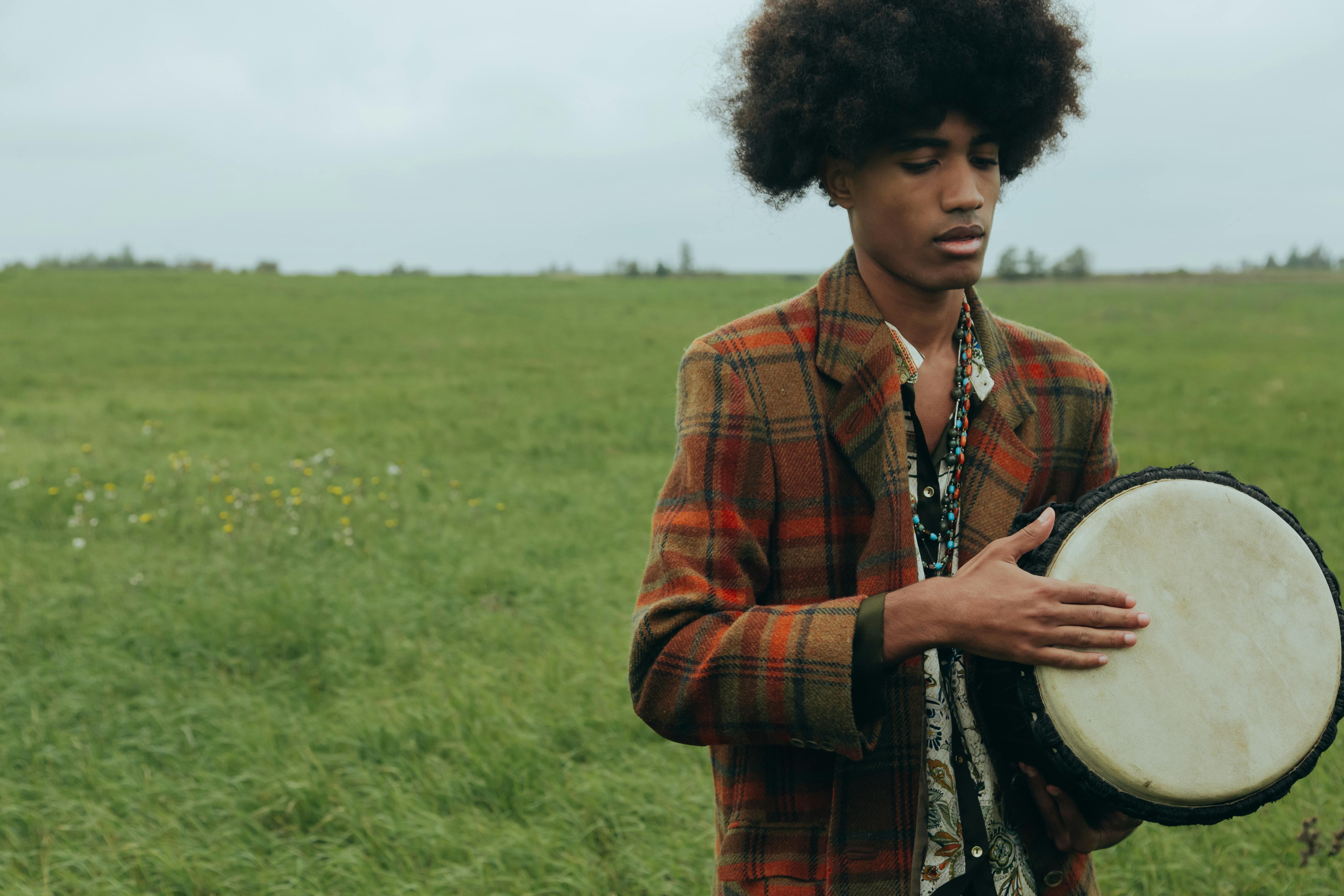 Man with Afro Hair Playing Djembe · Free Stock Photo
