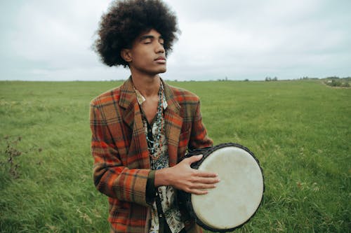 Man Holding a Djembe in the Field