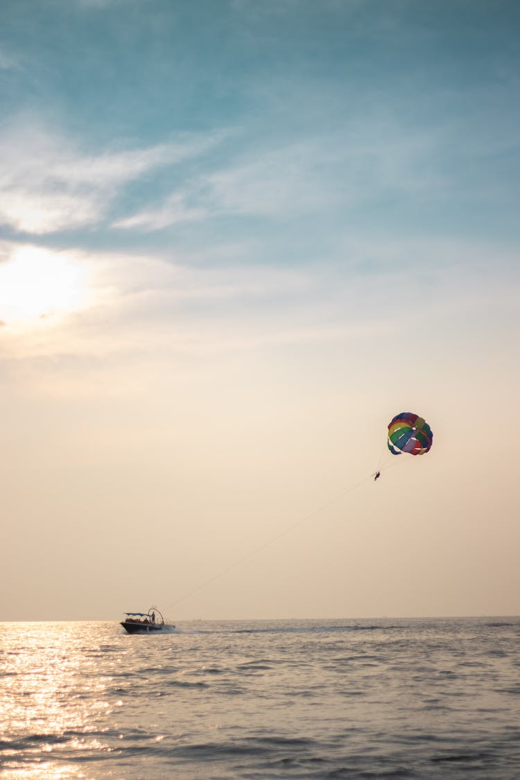 A Boat Pulling A Parasail Wing