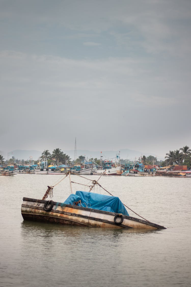 A Wooden Boat Sinking In The Bay