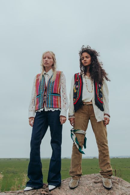 Two women in bohemian outfits standing outdoors, showcasing unique fashion.