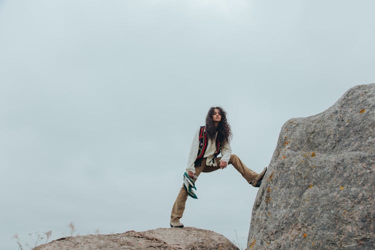 A Person Standing On Gray Rock In Low Angle Shot