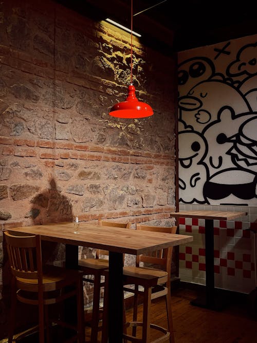 Brown Wooden Table and Chairs With Red Pendant Lamp