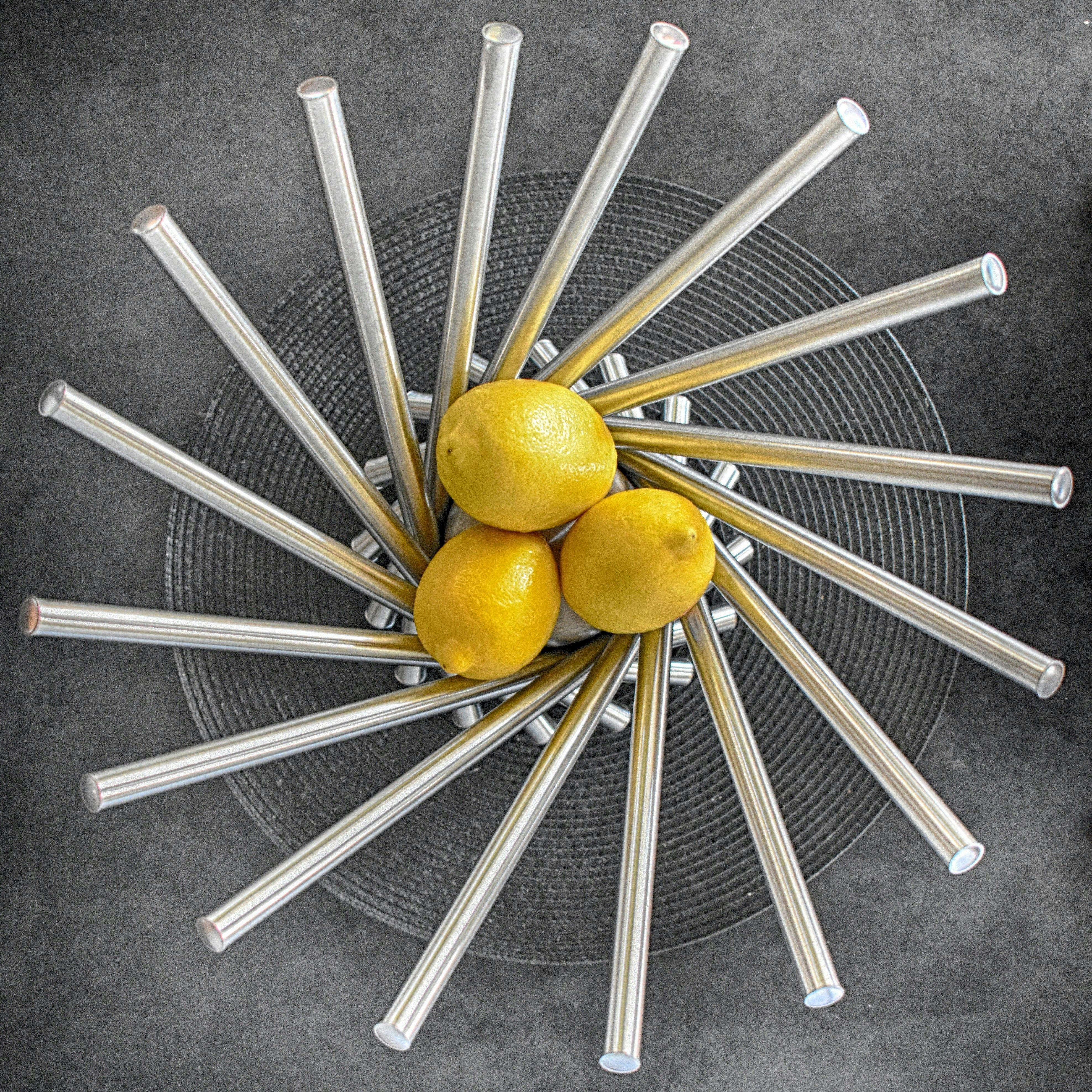 Three Lemon Fruits on Steel Bowl