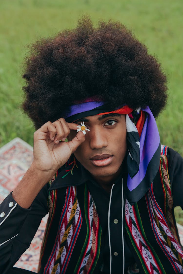 Man With Afro Hair Holding Delicate Flower