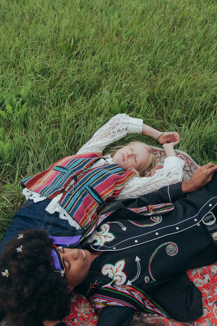 Man And Woman Lying On Grass