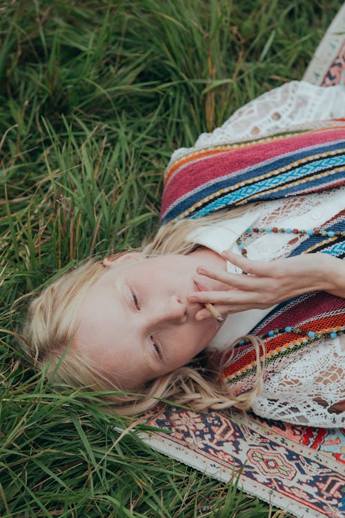 Woman with Blonde Hair Smoking a Cigarette