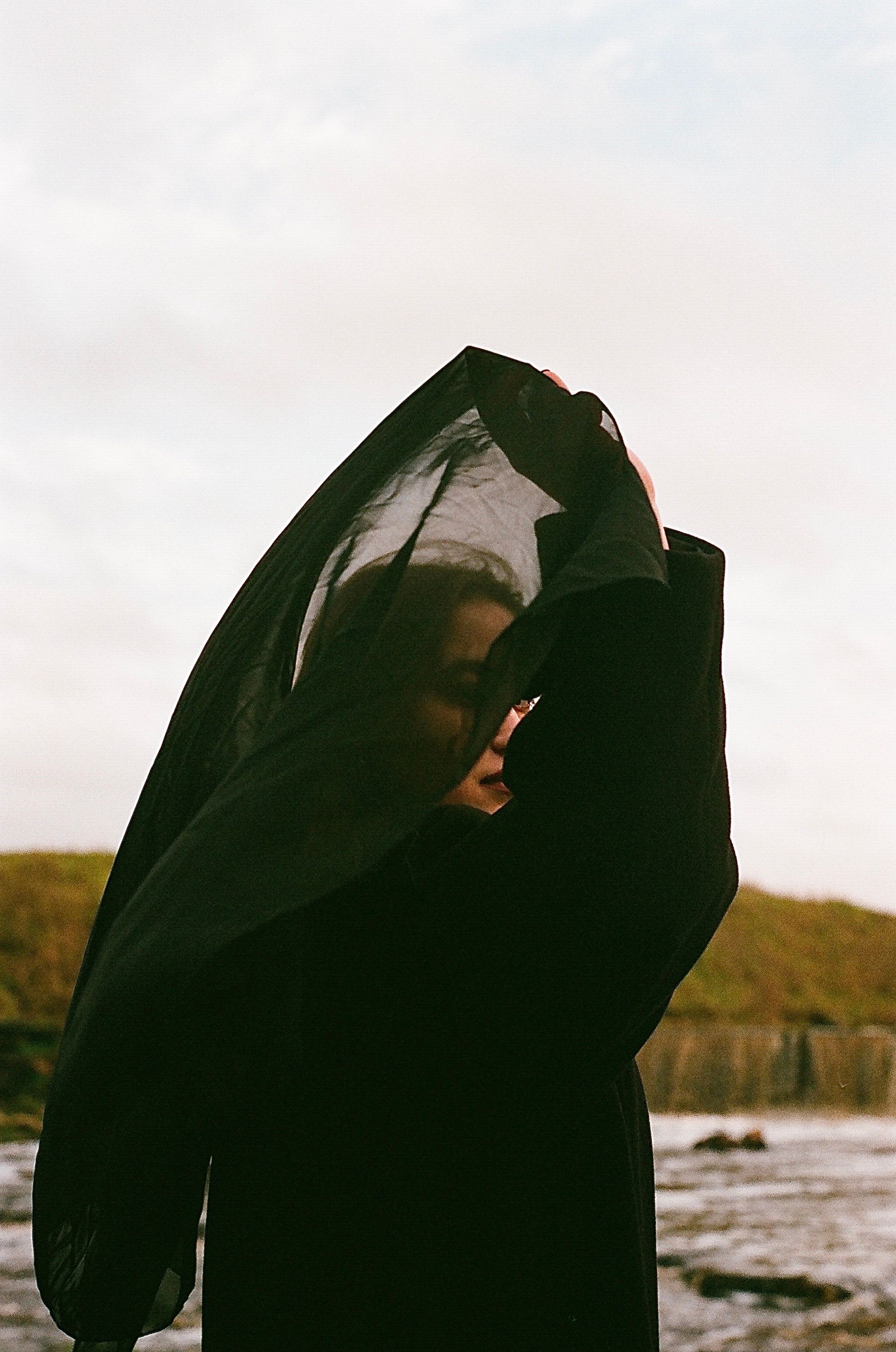 A Woman Covering Her Face with a Black Veil · Free Stock Photo