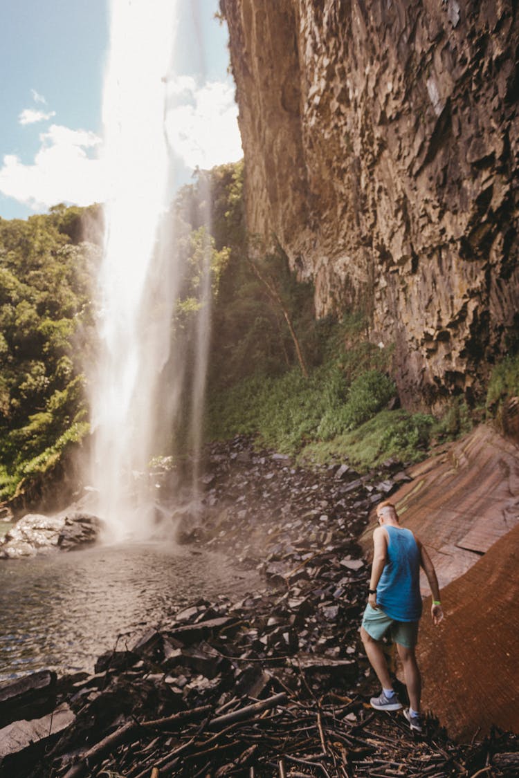 Man Beside Waterfall