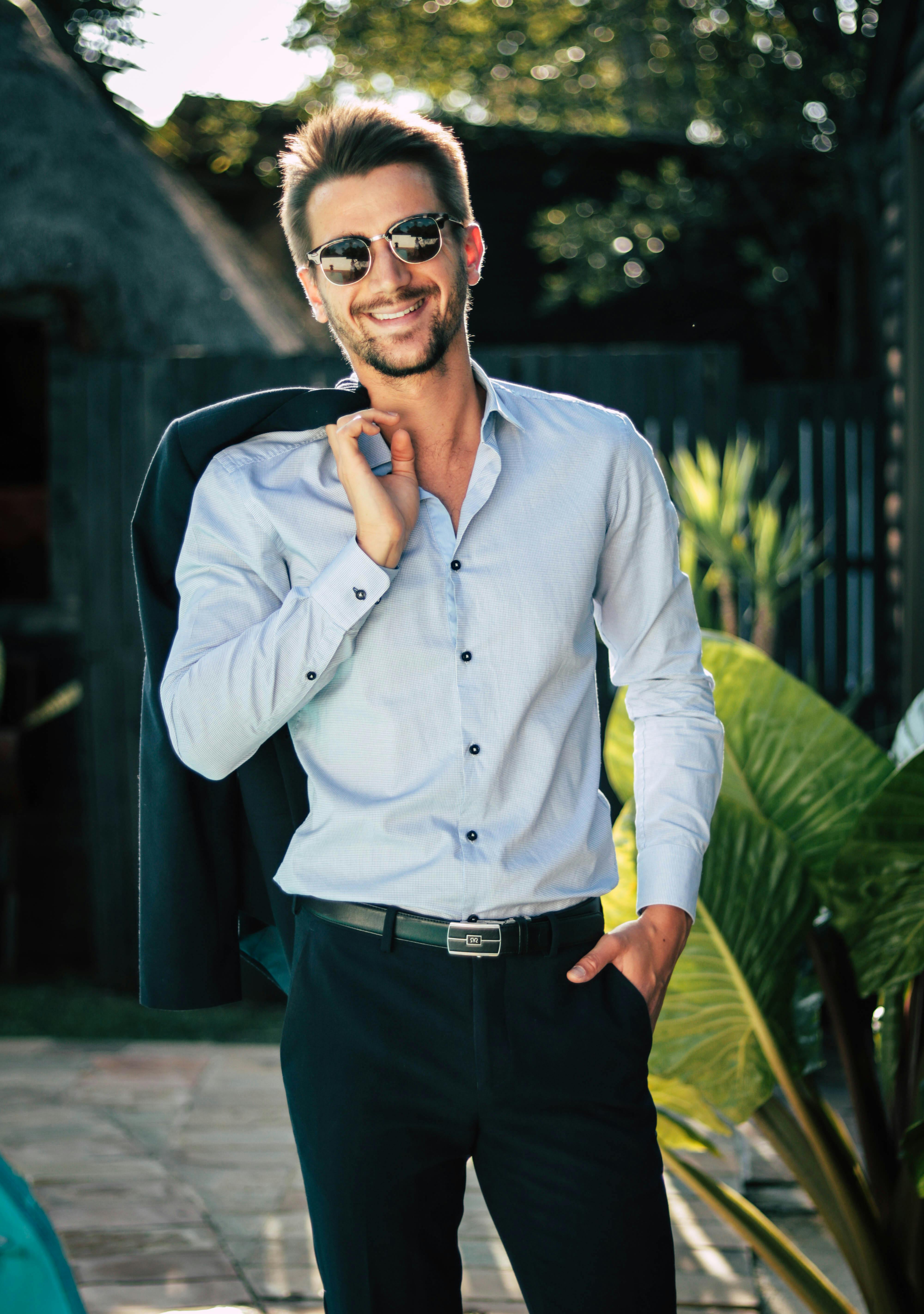 Man holding his suit jacket. | Photo: Pexels