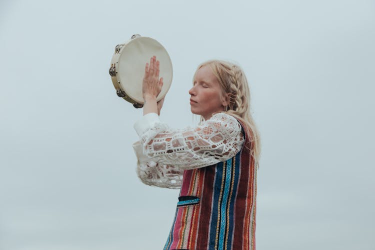 A Woman Playing Tambourine