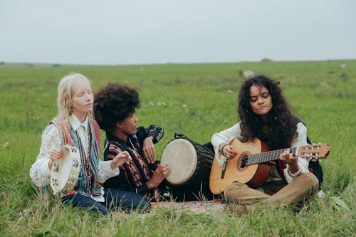 Man and Women Playing Musical Instruments in the Field