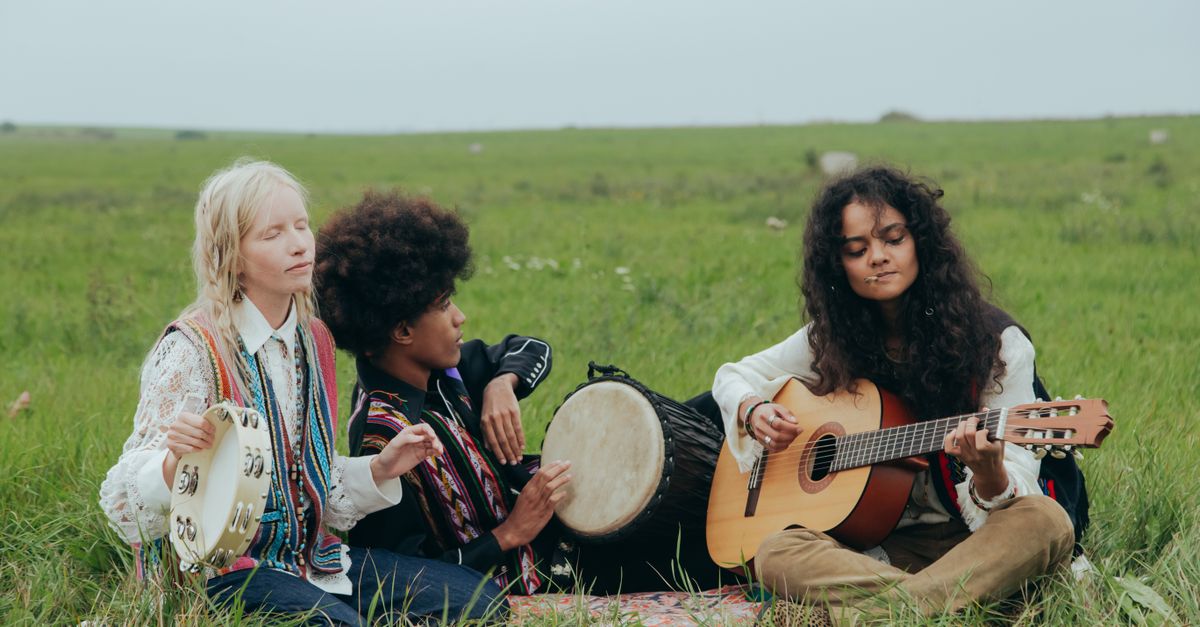 A group of diverse students jamming in a circle with acoustic instruments