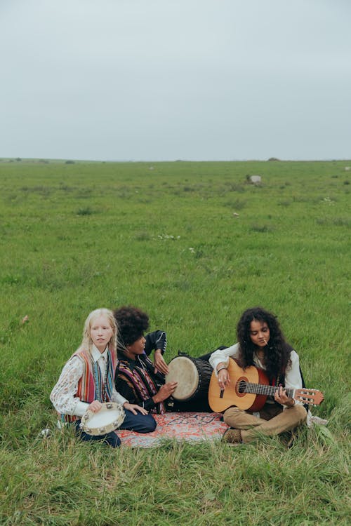 People Playing Musical Instruments in the Field