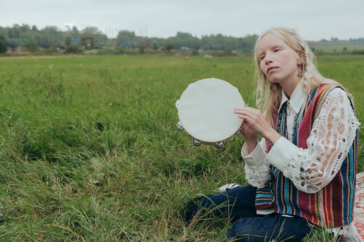 Blond Woman Holding A Tambourine