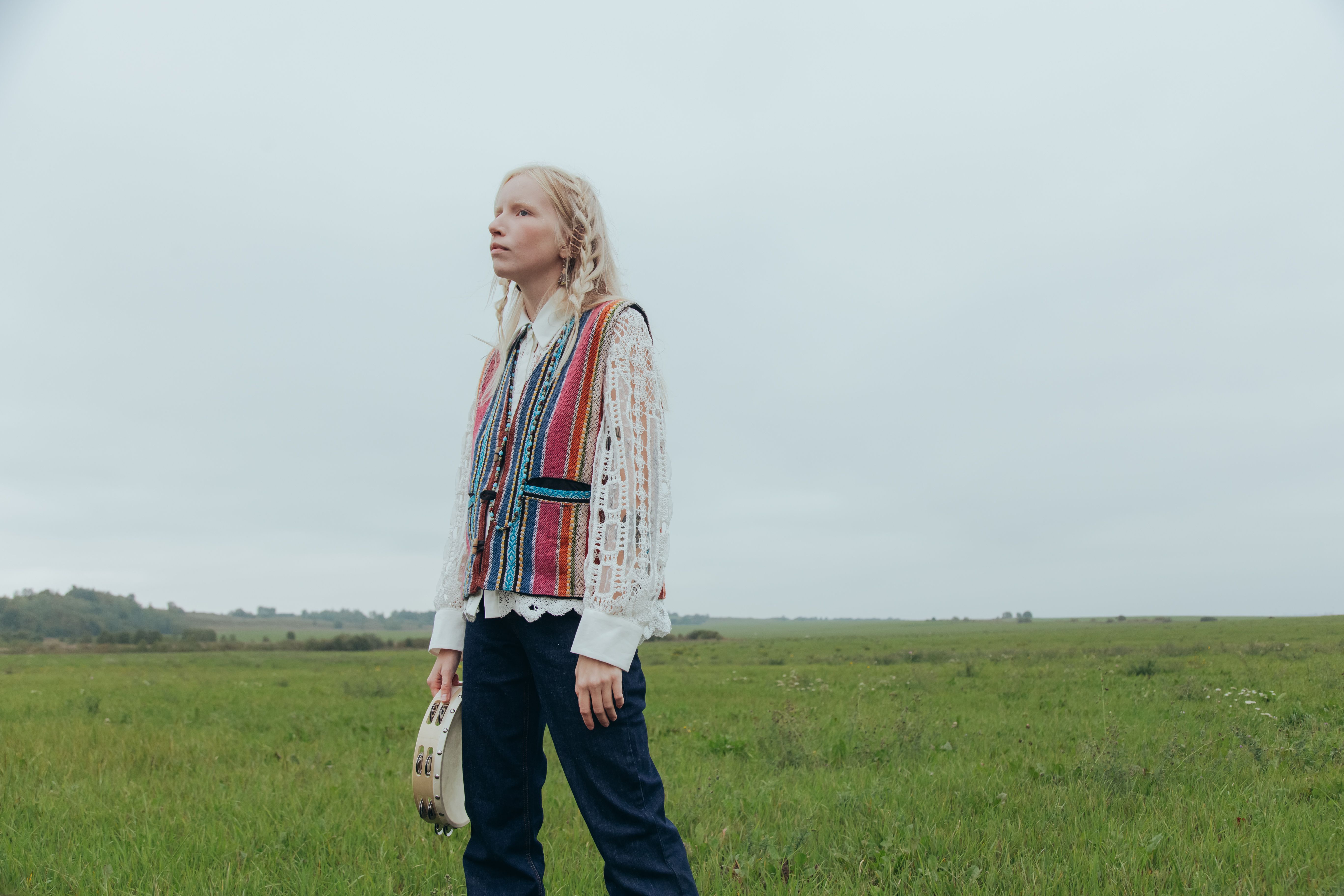 A Woman in Black Jacket Standing on Brown Grass Field · Free Stock Photo