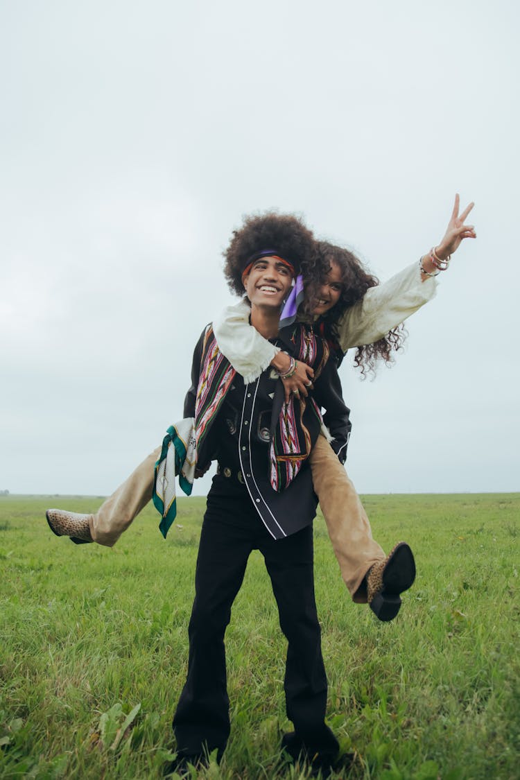 Man With Afro Hair Carrying A Woman On His Back