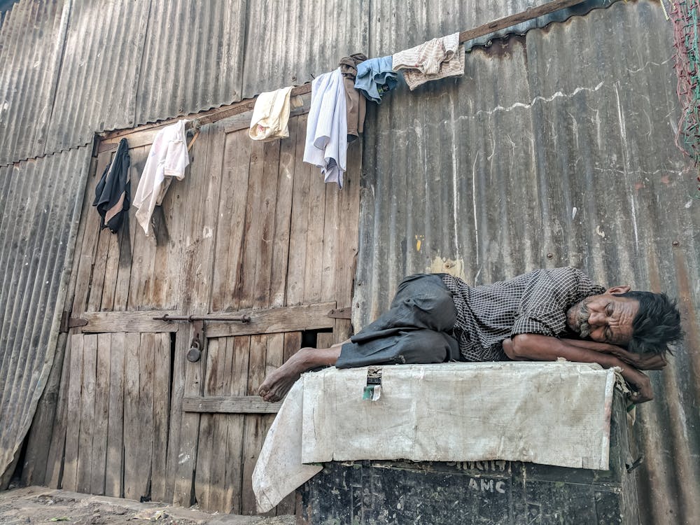 Man sleeping in front of a building
