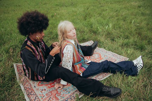 A High Angle Shot of a Couple Sitting on a Picnic Blanket