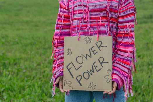 A Protester in a Pink Sweater Holding a Placard