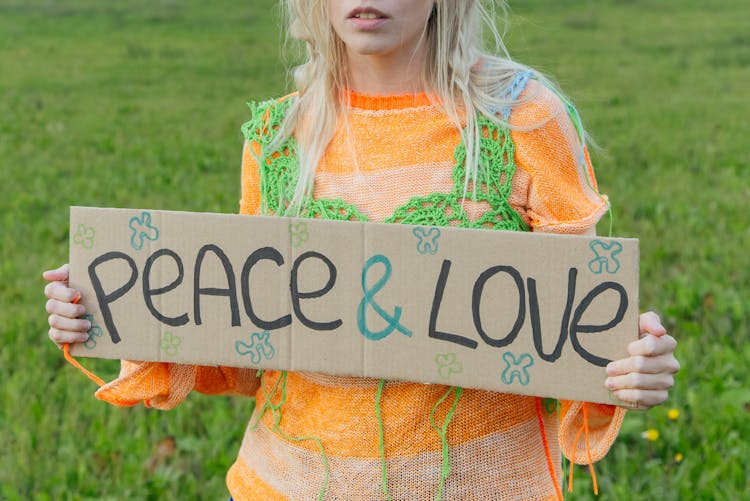 A Woman Holding A Cardboard With Message