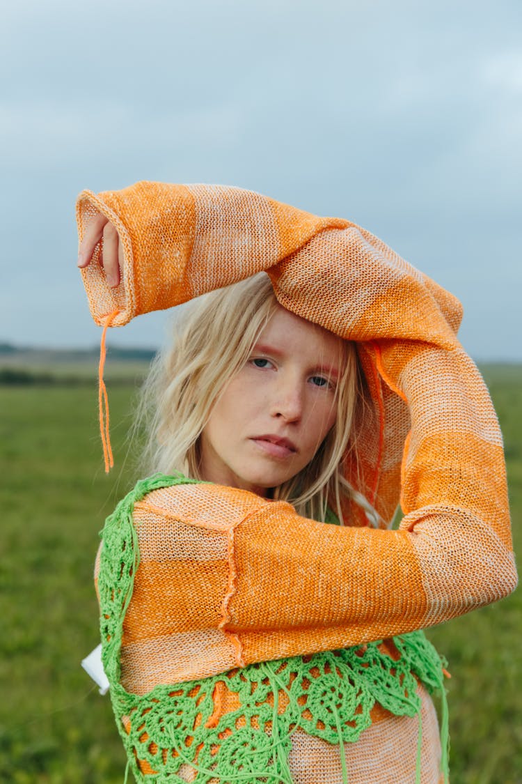 Woman In Orange Sweater And Green Crochet Top