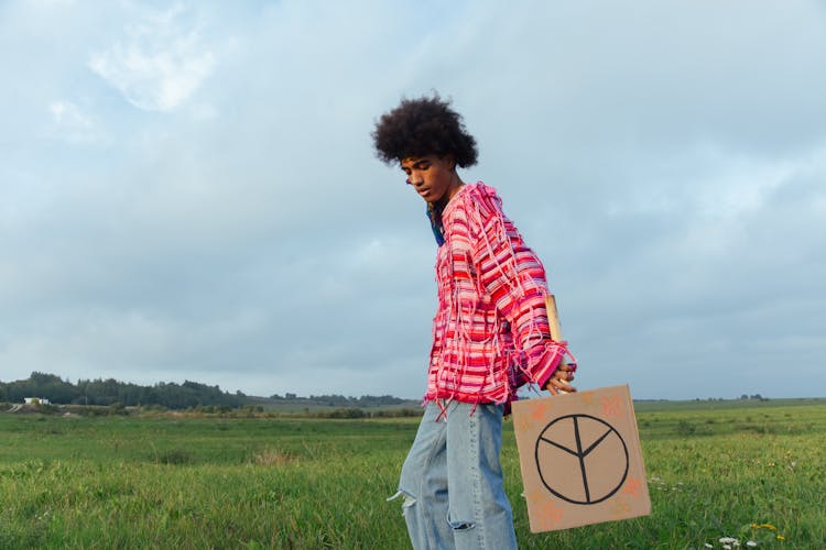 Man Holding Board With Peace Sign