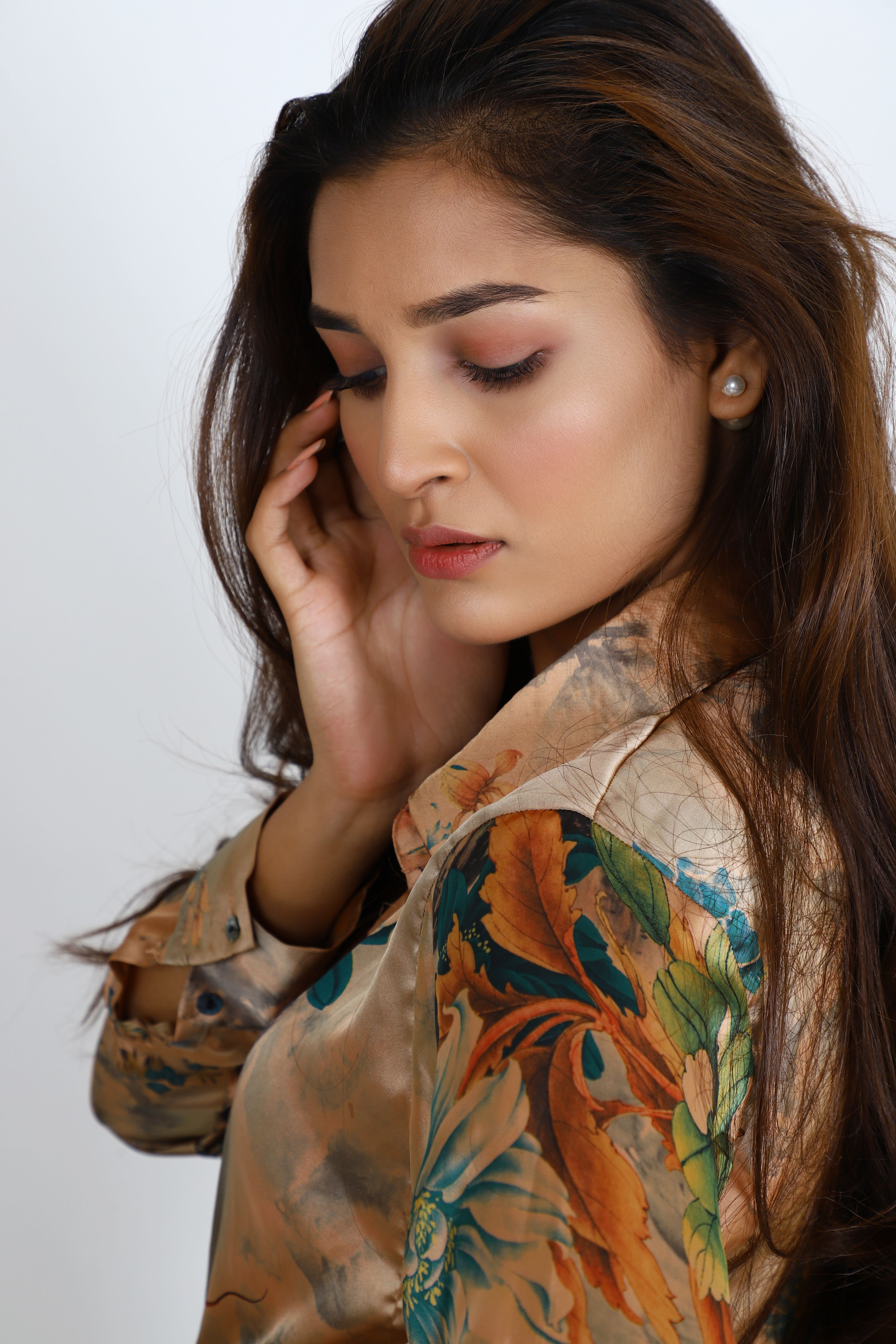 Side view portrait of a woman posing in floral long sleeves, captured in Lahore. Elegant and serene expression.