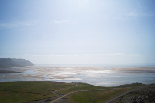 Breathtaking aerial shot of Raudisandur Beach's unique sand patterns under a clear sky in Iceland.