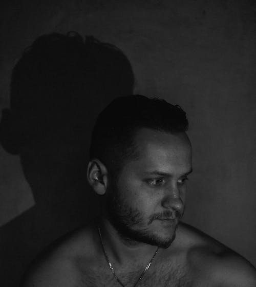 Grayscale Photo of a Shirtless Man