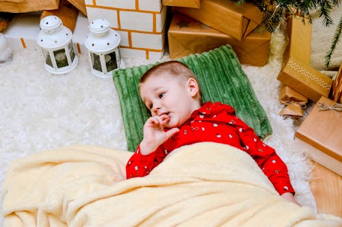 A Young Boy Lying on Fur Carpet