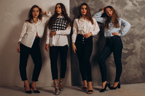 Free A group of fashionable women posing in a studio wearing smart casual outfits. Stock Photo