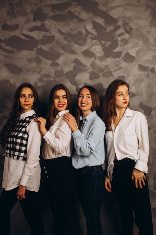 Free Four fashionable women posing confidently in a studio portrait. Stock Photo