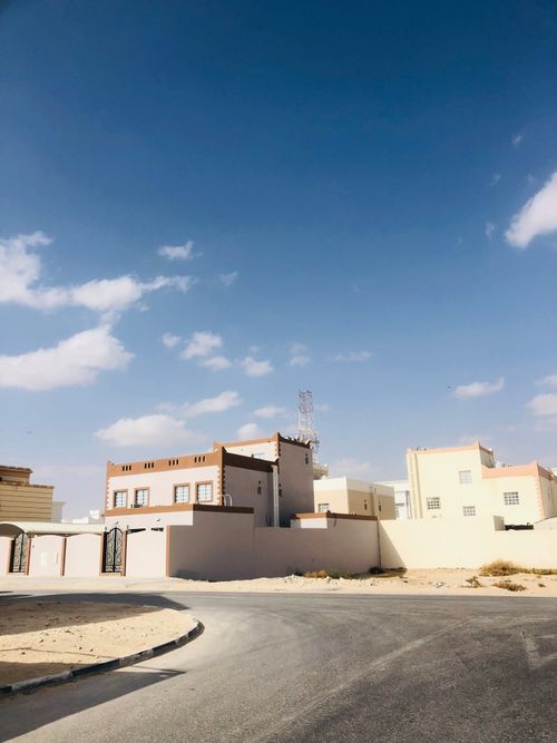 Free A view of modern urban houses under a bright blue sky, showcasing architectural design in a residential area. Stock Photo