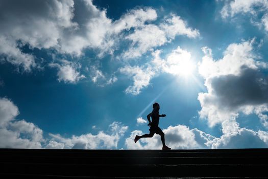 Dynamic silhouette of a person running with a bright sky in São Paulo, capturing motion and tranquility.