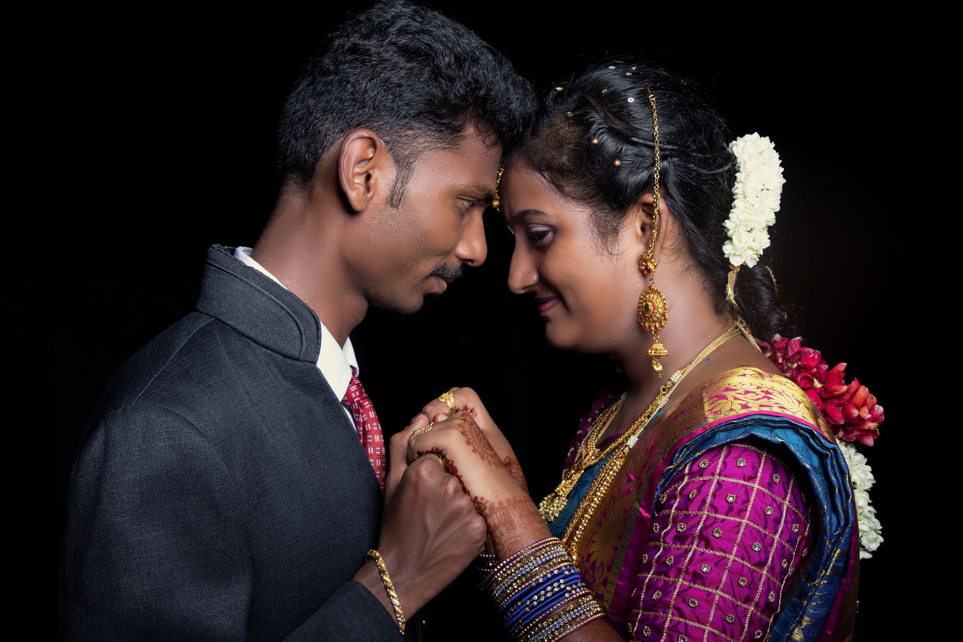 South Asian couple in a romantic pose at their wedding ceremony, showcasing love and tradition.