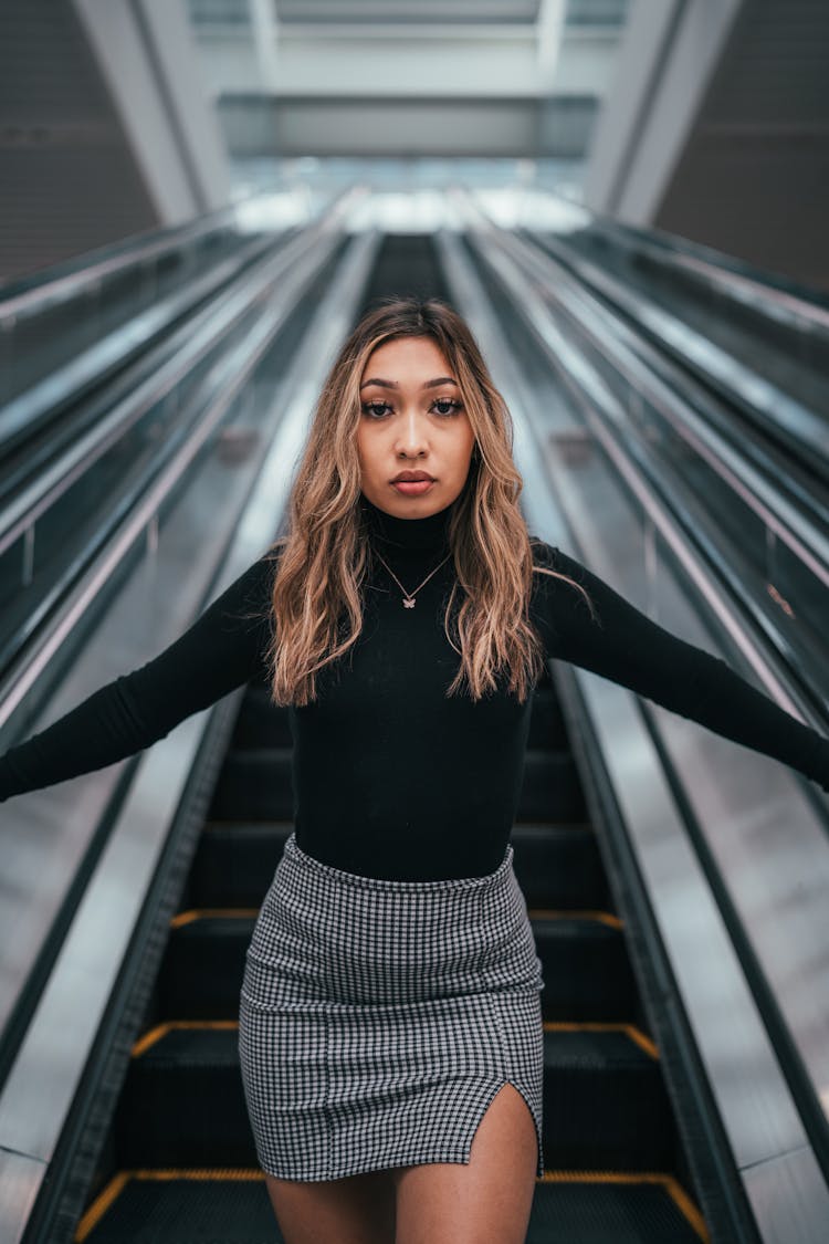 Woman Standing On Escalator