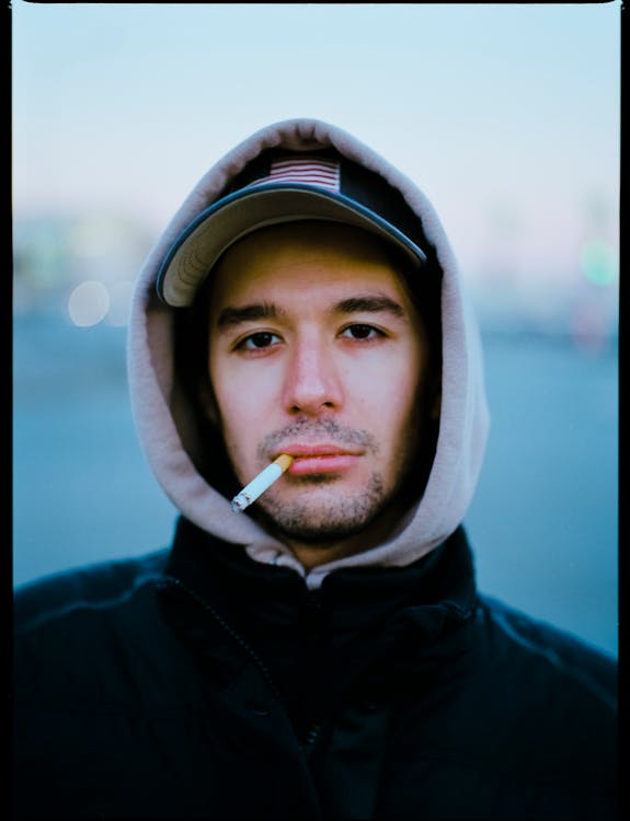 Man in Hoodie Smoking Cigarette